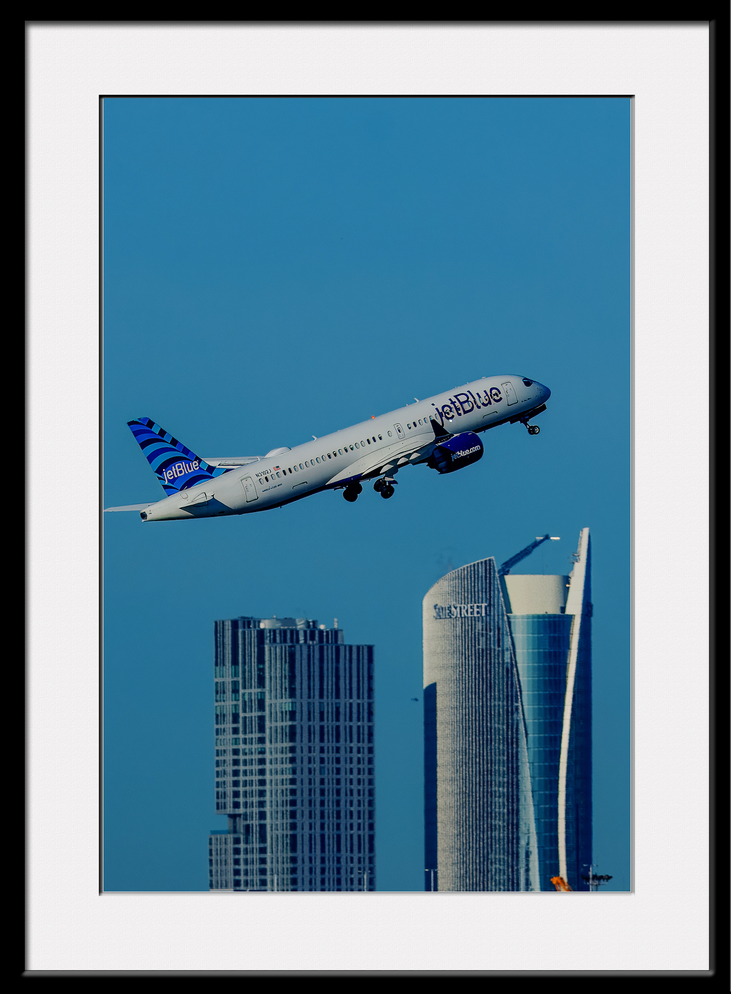 Jet Blue over Boston Buildings