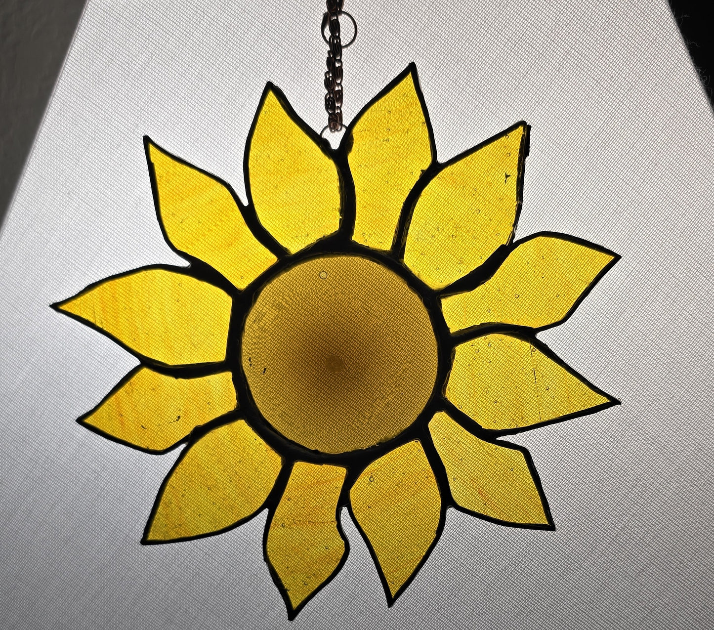 Yellow sunflower-shaped object on a gray background