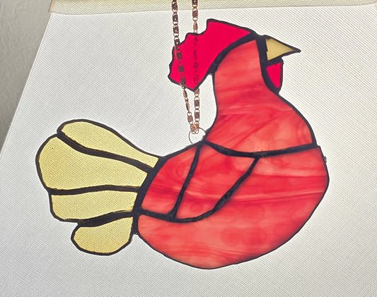 Red and yellow bird-shaped ornament on a white background